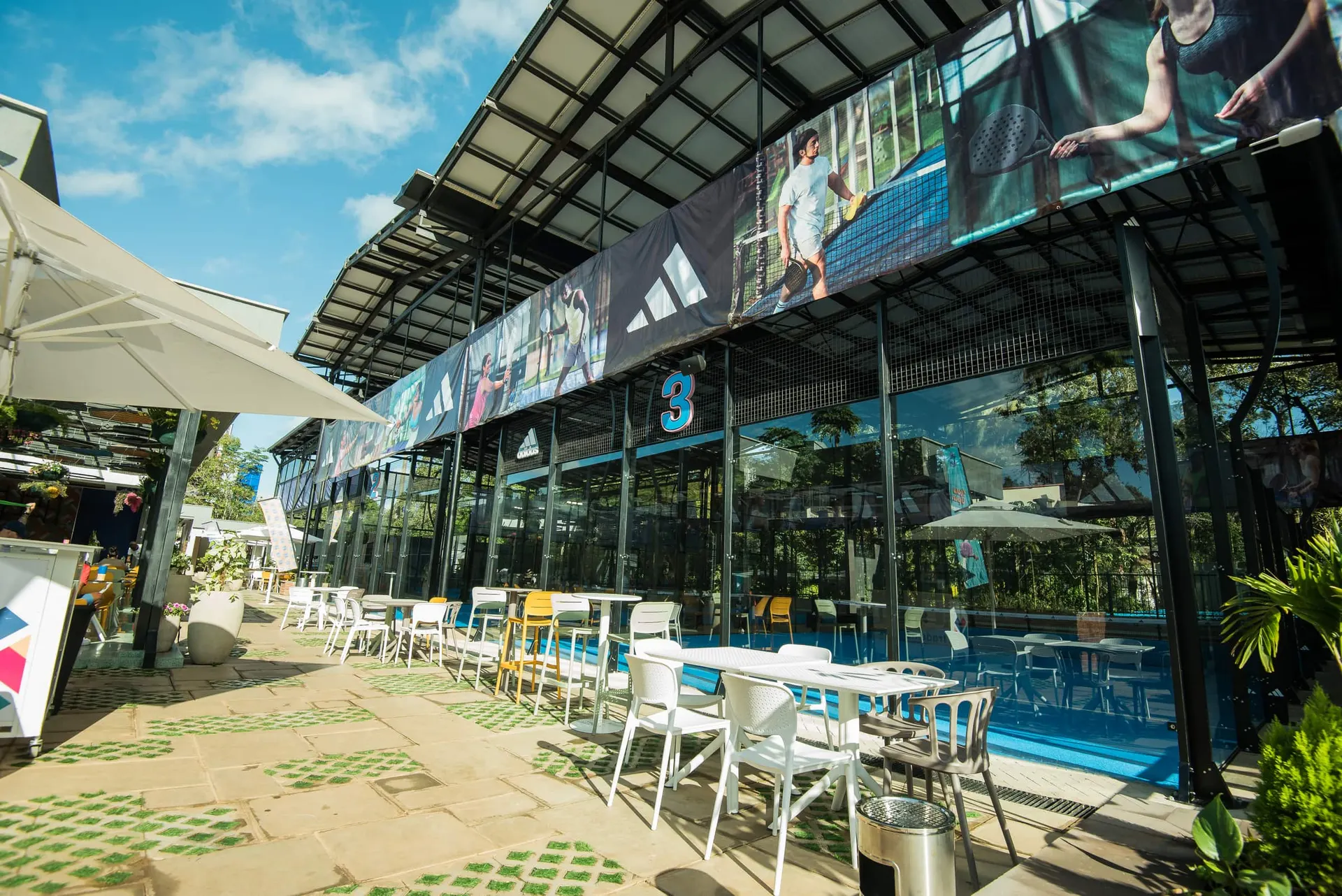 Vamos restaurant terrace with umbrellas and the pool beyond.