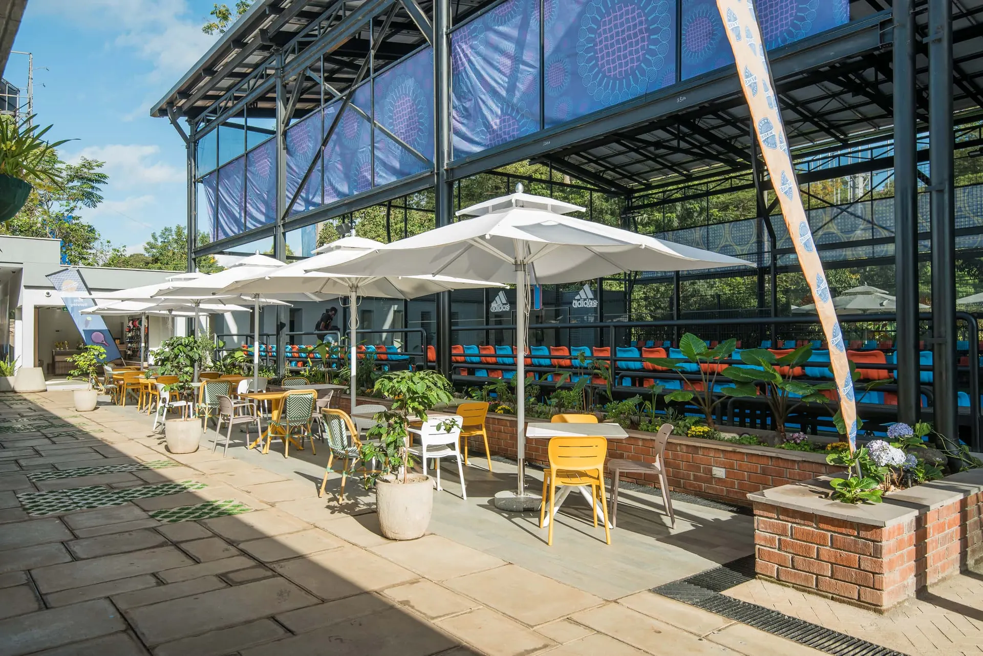 Shaded dining terrace threaded with planting and paving.