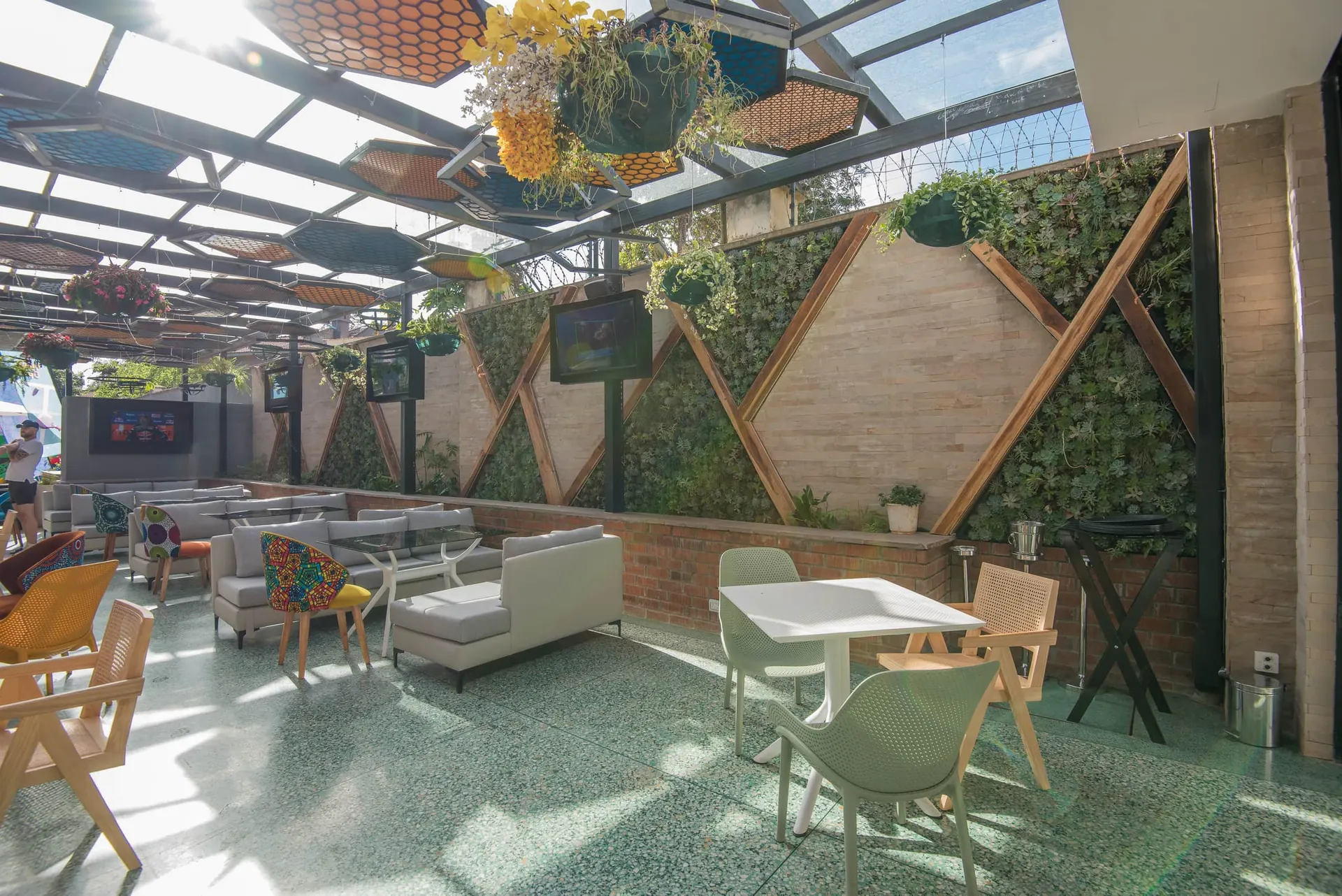 Lounge seating with timber screens and hanging greenery.